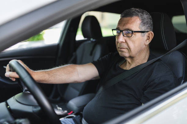 istock Senior in his 70s driving a car 1412652426