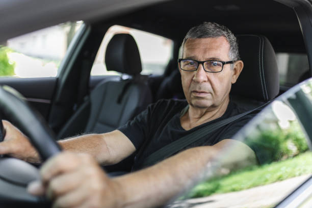 istock Senior in his 70s driving a car 1412653046