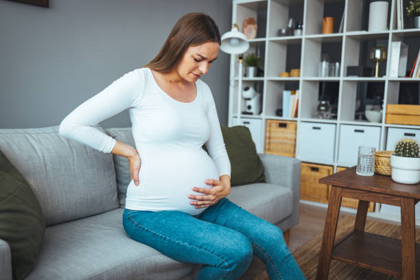 istock Young sick woman with hands holding pressing her crotch lower abdomen. 1412653223