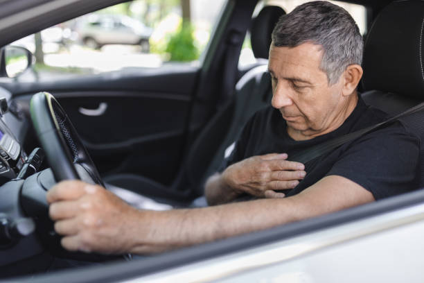 istock Senior behind the steering wheel with chest pain 1412653356