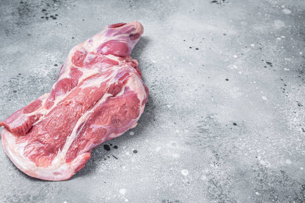 istock Raw lamb shoulder meat on butcher table. Gray background. Top view. Copy space 1412654241