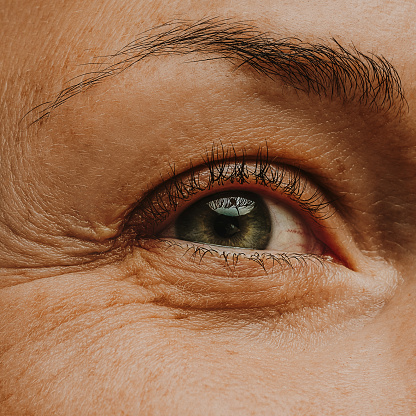 mature woman adult eye skin and wrinkles\nunretouched and no make up\nMacro photo of part of face