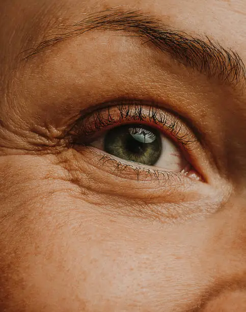 Photo of mature woman adult eye skin and wrinkles macro close up