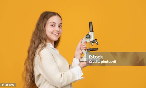 Smiling Kid With Microscope On Yellow Background Stock Photo - Download Image Now - Chemistry, Chemistry Class, Child