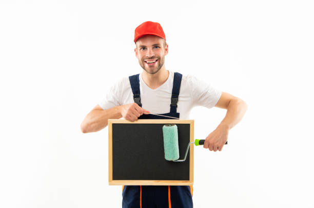 istock man with paint roller and blackboard for copy space isolated on white, announcement. 1412657120