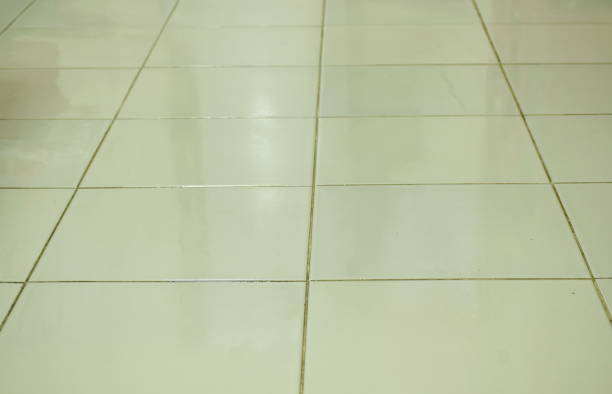 wet tile floor danger for slip stock photo