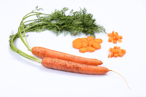 Fresh curved carrot, isolated on black. Strange vegetables