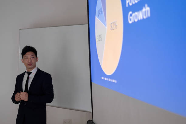 istock Asian  businessmen presenting chart in meeting room 1412660664