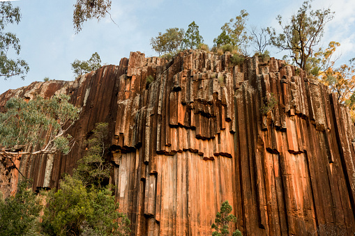 Organ piping columnar basalt rock formation. Sawn Rocks at Mt. Kapatur National Park, NSW, Australia. Rare hexagonal organ piping rock formation - remains of volcanic lava flow