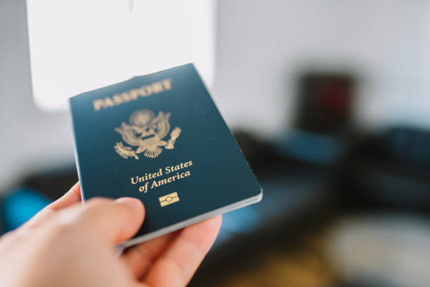 istock Hand holding a American passport. 1412665399