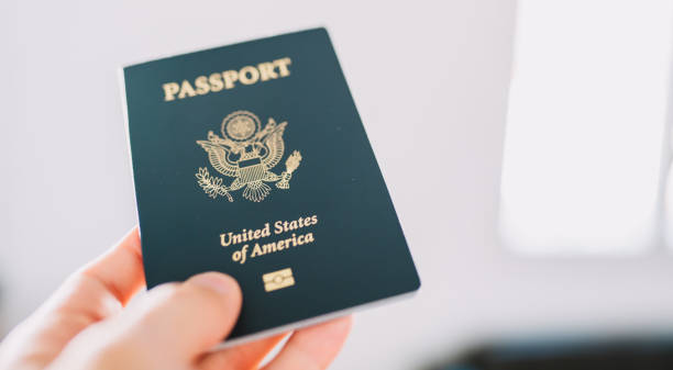 istock Hand holding a American passport. 1412665403