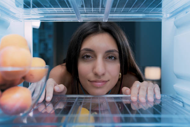 istock Woman cooling herself in the fridge 1412665813