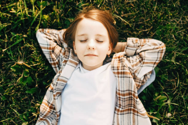 istock A girl lies on the grass 1412665885