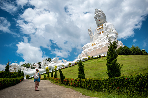 Tourist touring beautiful Guan Yin temple, Great White Buddha in Chiang Rai, Thailand. Tourist walking towards the Guan Yin temple, Great White Buddha in Chiang Rai, Thailand.