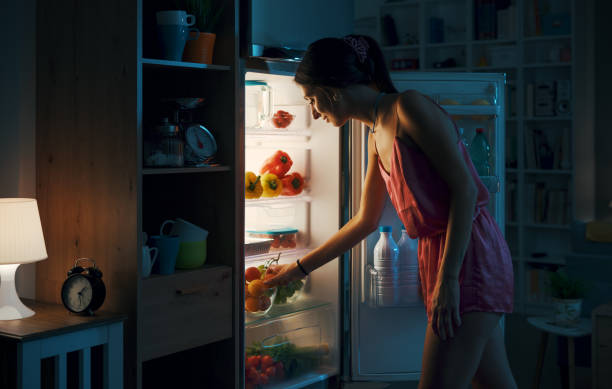 istock Woman looking in the fridge 1412666728