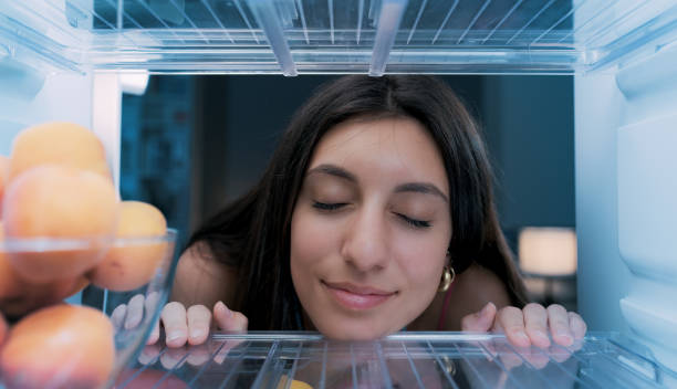 istock Woman cooling herself in the fridge 1412666806