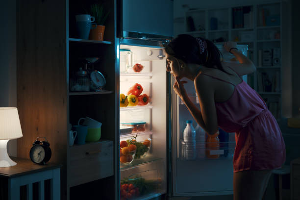 istock Woman looking in the fridge 1412667048