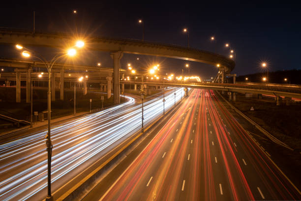 istock Modern highway at night with car light trails 1412668226