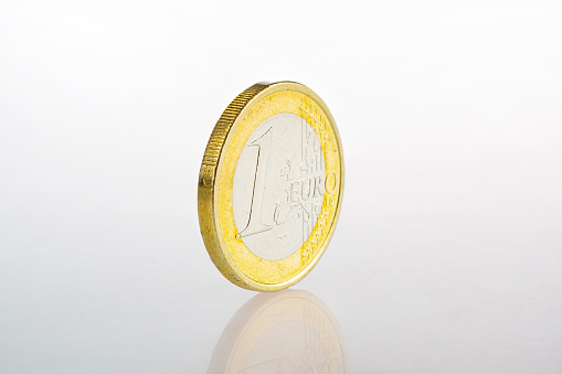 Shiny Euro coin - close-up, white background