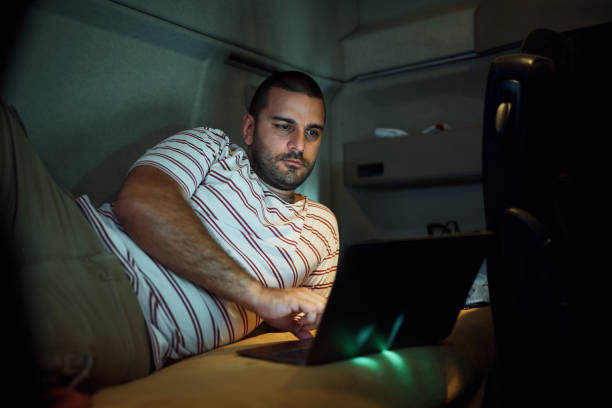 istock Truck driver using laptop in a cabin at night. 1412670842