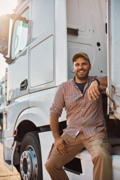 istock Happy professional truck driver outdoors looking at camera. 1412671866