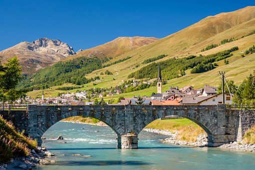 The famous stone Inn Bridge (Inn Brücke) over the Inn river is located near the village of S-Chanf in the Upper Engadine Valley (Grisons, Switzerland). The Swiss National Park is not far away.