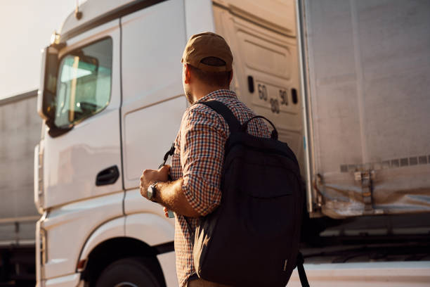 istock Back view of truck driver coming to work. 1412672584