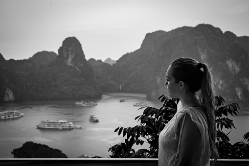 Tourist in Halong Bay on a rainy day. Halong Bay, Vietnam. Halong Bay rainy day. Halong Bay in black and white