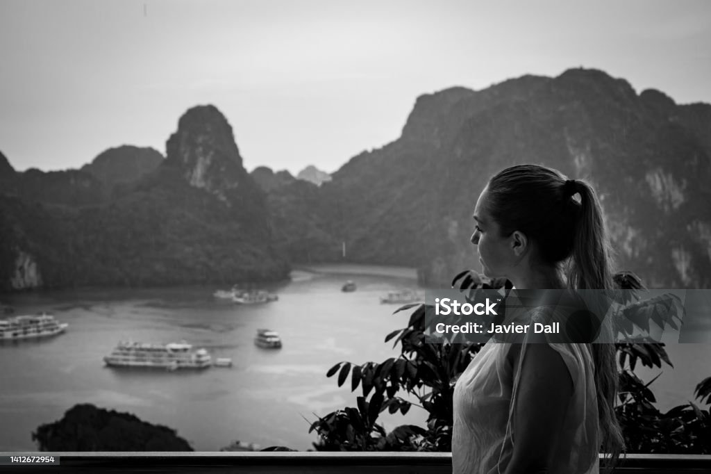 Tourist in Halong Bay on a rainy day. Tourist in Halong Bay on a rainy day. Halong Bay, Vietnam. Halong Bay rainy day. Halong Bay in black and white Black Color Stock Photo
