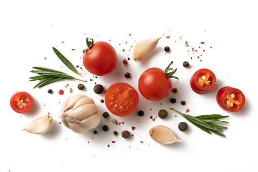 Ingredients for cooking, garlic, pepper, spices and herbs isolated on white background. top view. cherry tomatoes, garlic, ROSEMARY, SPICES