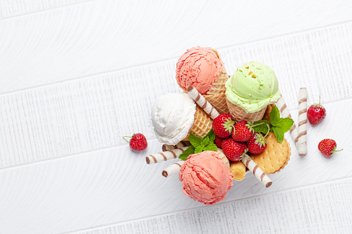 Various ice cream in waffle cones. Strawberry, pistachio and vanilla icecream. Flat lay with copy space