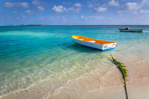 Idyllic beach with rustic wooden fishermen boat in Aruba, Dutch caribbean
