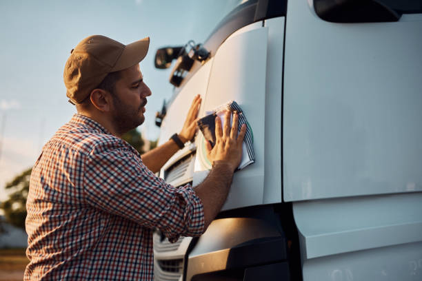 istock Young driver cleaning his truck before the ride. 1412675173