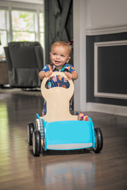 istock Eleven Month Old Baby Boy Pushing Toy Walker 1412677273