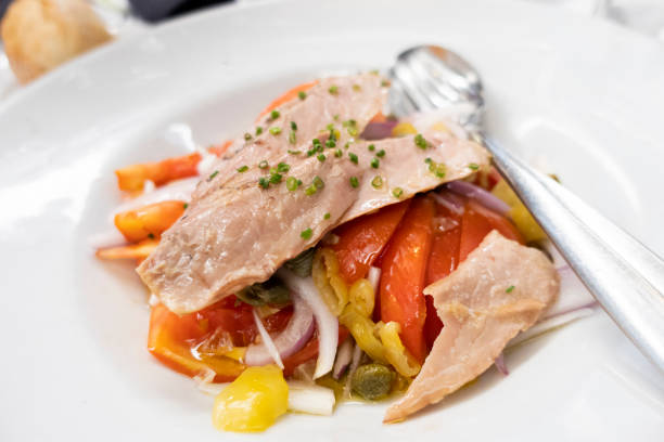 refreshing tuna belly tuna salad with peppers and onion in a white dish stock photo