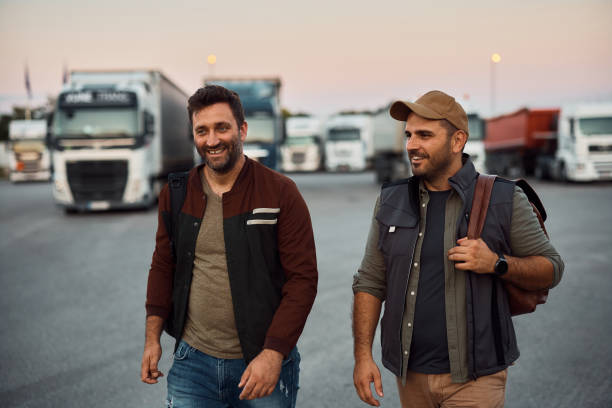 istock Happy truck drivers leaving parking to after work. 1412678639