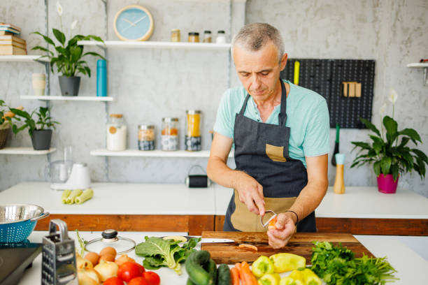 istock Mature man prepares carrots for lunch 1412679524