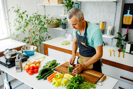 Man prepares parsley for soap