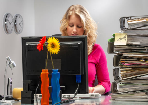 istock Young woman in office working late 1412680916