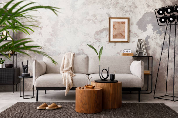 istock Modern composition at living room interior with design grey sofa, armchair, wooden coffee table, lamp and elegant personal accessories. Loft and industrial interior. Template. 1412683408