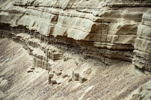 Surface sandy shore. Close-up of sandy rock.