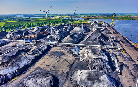 coal handling terminal and storage with windmills in the background.