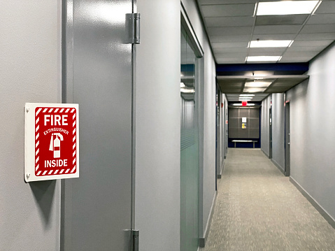 fire extinguisher sign on a wall of a corridor
