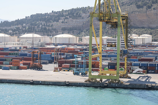 10th June 2022 - Shipping containers being loaded/unloaded at Barcelona port by automated straddle carriers allowing precise stacking and optimisation of shipping containers