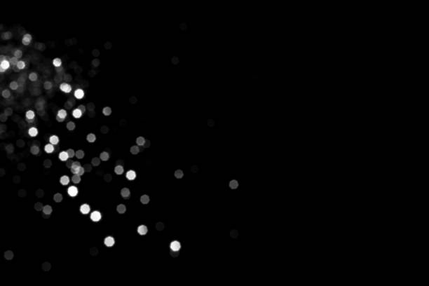 istock White gray blurred bokeh lights on black background 1412690385