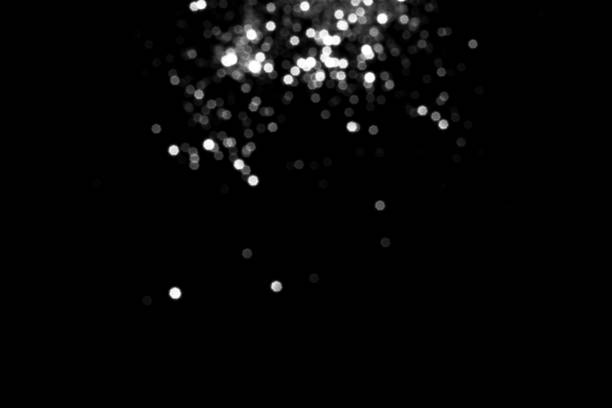 istock White gray blurred bokeh lights on black background 1412690416