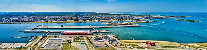 Netherlands, IJmuiden - 20-06-2022: Aerial view of heavy industry. Near the sea lock in the Noordzeekanaal.