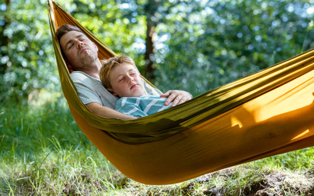 istock Father and Son Napping in the Hammock 1412690923