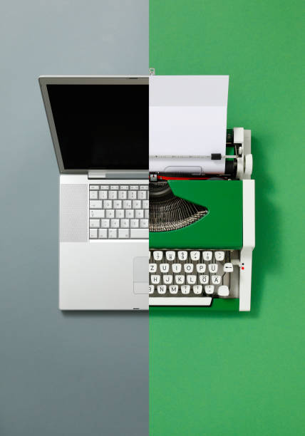 Close up of businesswoman using laptop at desk in creative office
