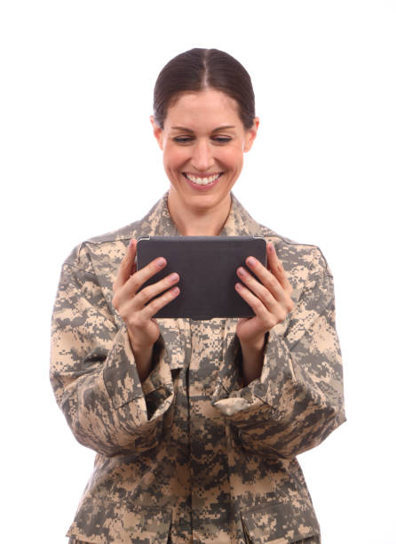 istock Military Woman on White Background with Tablet Smiles Vertical 1412692183